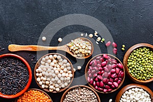 Legumes, seeds and cereals on a dark background. Healthy food. Top view