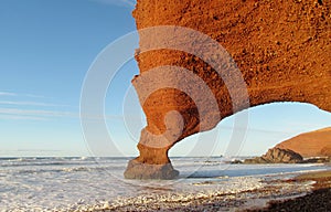 Legzira stone arch on beach in Morocco photo
