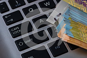 Lei banknotes on keyboard. Selective focus on stack of LEI romanian money