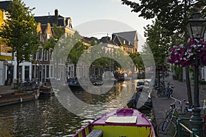 Houses, boats and bicycles at the Oude Rijn canal in the evening