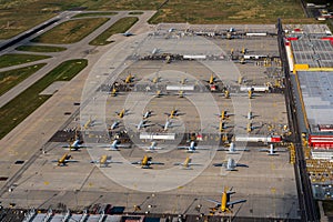 Leipzig, DHL cargo hub with main cargo apron, main buildings and hangar and many cargo airplanes parked on apron - aerial view