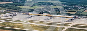 Leipzig DHL cargo hub with main buildings and cargo airplanes parked on apron - aerial view