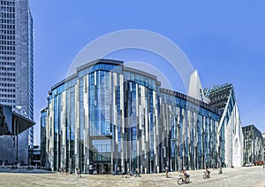 Students in front of the modern University of Leipzig on a hot summer day