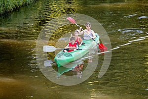 Family on kayaks and canoe acitvity tour at Elsterflutbett river in Leipzig. Leisure and healthy