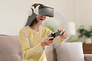 Leisure activities concept, Young woman playing exciting game with VR glasses and joystick console