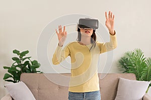 Leisure activities concept, Young woman touching the air to experience the virtual with glasses VR