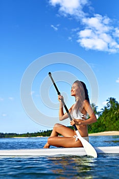 Leisure Activity. Woman Stand Up Paddling, Surfing. Recreational