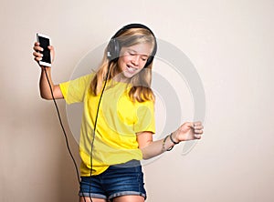 Leisure concept. Happy pre teen or teenage girl in headphones li