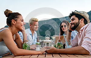 Leisure holidays vacation people and food concept. Happy friends having dinner at summer party