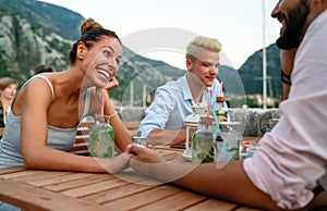 Leisure holidays vacation people and food concept. Happy friends having dinner at summer party