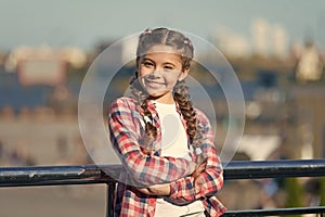 Leisure options. Free time and leisure. Girl cute kid with braids relaxing urban background defocused. Organize