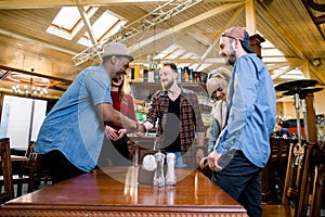 Leisure, people and holidays concept - group of five young multiracial smiling friends having a meeting in cafe