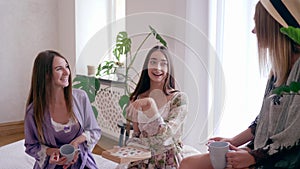 Leisure time, girlfriends gossiping during tea party with cups and box of candy