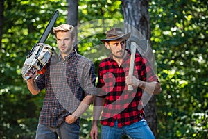 Leisure time together. summer or spring activity. man farmers relax in forest. rangers use equipment. Lumberjack with