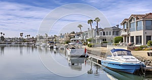 Leisure Watercrafts Docked by Beach side Homes Under a Cloud-Streaked Sky photo