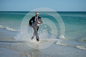 Leisure weekend and remote freelance work. Crazy comic business man in suit run on sea. Funny businessman with laptop