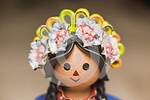 Lele doll with flower bows with skulls, traditional Mexican crafts made of clay