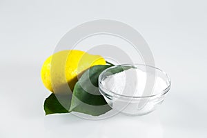 Lemon acid and lemon fruits on the white background.