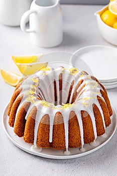 Lemon bundt cake drizzled with powdered sugar glaze
