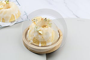 Lemon cake with sugar frosting on marble table. Healthy dessert. Delicious breakfast, traditional tea time treat.