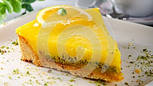 Lemon cheese cake with sauce served on a white plate