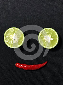 Lemon and chili and a smile face by arranging them.