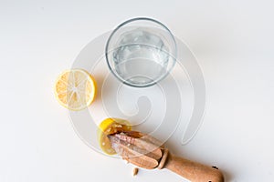 Lemon with citrus reamer and water