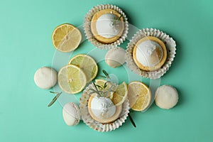 Lemon cupcakees, macaroons and ingredints on mint
