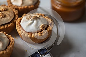 Lemon curd tartlets with whipped meringue and caramel sauce