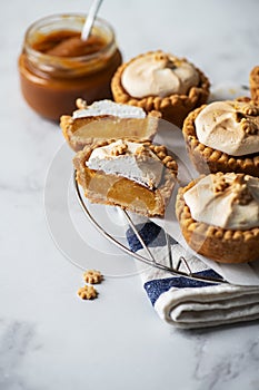 Lemon curd tartlets with whipped meringue and caramel sauce