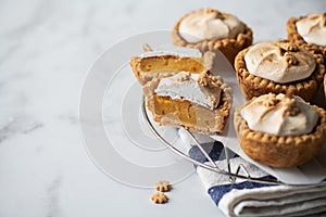 Lemon curd tartlets with whipped meringue. Copy space