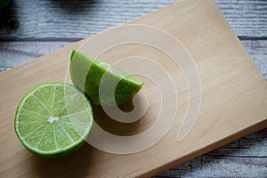 A lemon cut in half on a chopping board photo