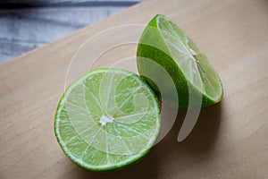 A lemon cut in half on a chopping board photo