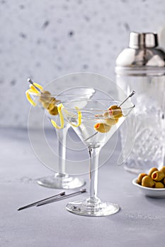 Lemon drop martini cocktail with olives and a lemon twist