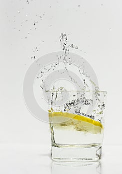 Lemon dropped into a glass