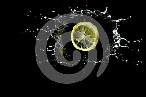 Lemon is dropped in water splash