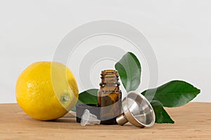 Lemon Essential Oil Bottle With Black Cap, Citrus Leaves and Funnel