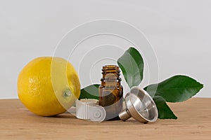 Lemon Essential Oil Bottle With White Cap, Citrus Leaves and Funnel
