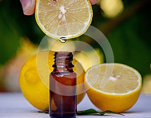 lemon essential oil and lemon fruit on a wooden white board