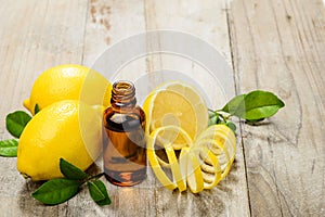 Lemon essential oil and lemon fruit on the wooden board