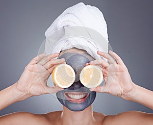 Lemon, face mask and woman cover eyes for healthy skincare, beauty and anti aging wellness makeup in studio. Happy