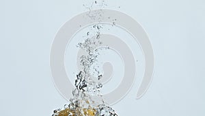 Lemon fruit falling water in bubbles closeup. Summer fresh citrus rising surface