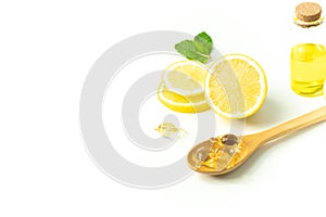 Lemon fruit juice with bottle and peppermint leaf with wood spoon and vitamin on white background in beauty spa skin treatment hea