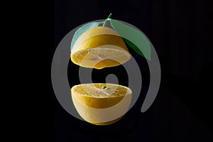 Lemon fruit with leaf isolated on black background