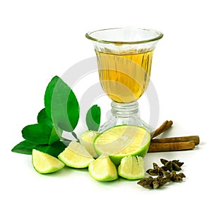 Lemon and green leaves with lime juice