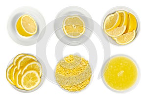 Lemon halves, slices, wedges, lemon zest and juice in white bowls