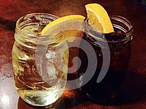 Lemon ice tea in mason jar with wedge of lemon