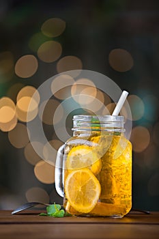 Lemon iced tea on wooden plate