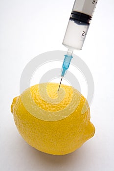 Lemon injected with syringe