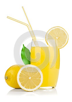 Lemon juice glass and fresh lemons